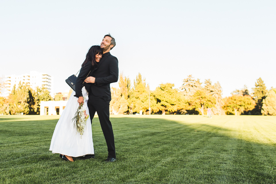 bride and groom laughing in congress park at wedding denver colorado